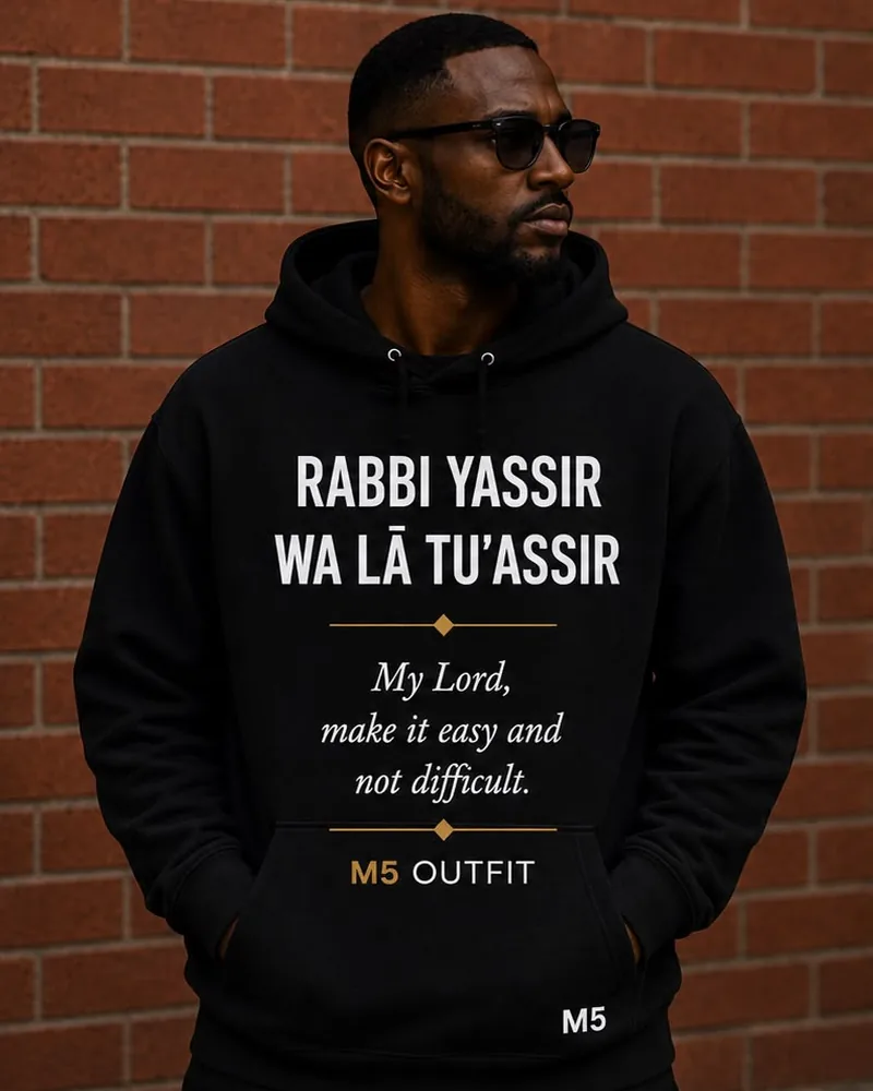 Model wearing a black M5 Outfit hoodie printed with the Arabic and English phrase Rabbi Yassir Wa La Tu'assir